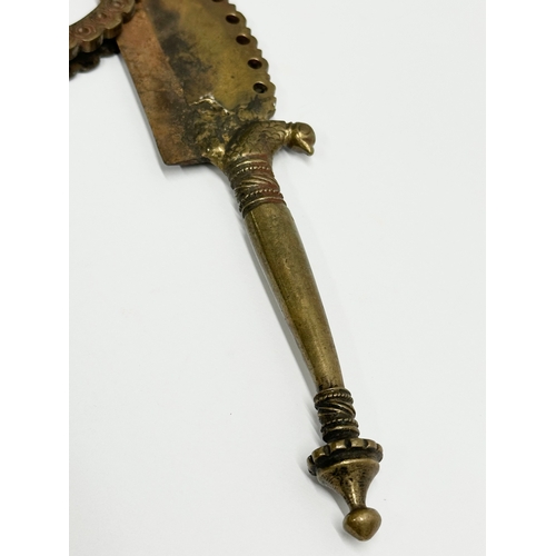 515A - A 19th Century Indian brass betel cutter. 19cm