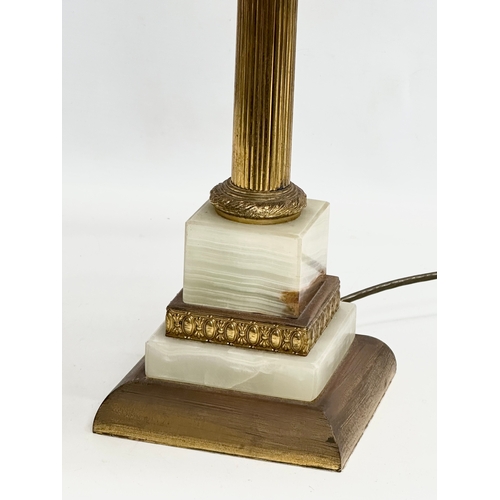 631 - A Mid 20th Century brass and onyx table lamp with Corinthian style column. 67cm