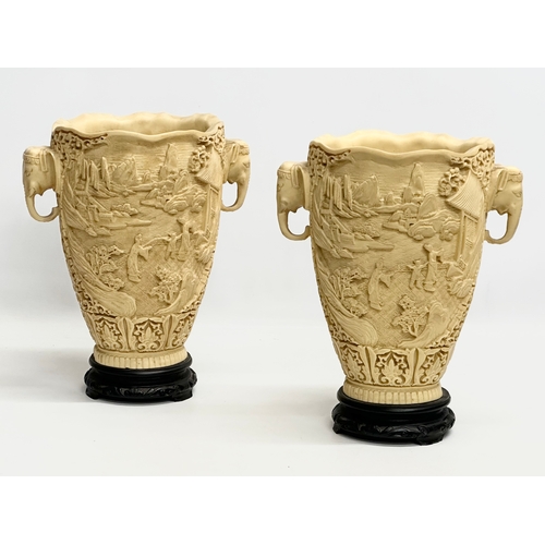 633 - A pair of large Mid/Late 20th Century Chinese carved resin vases on wooden bases. 25x19x31cm.