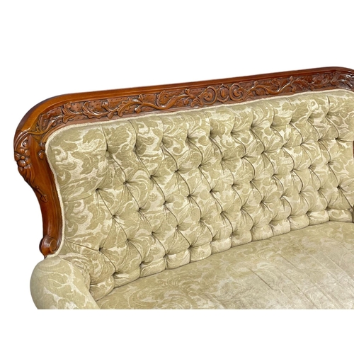 713 - A large Victorian style carved mahogany couch. 8