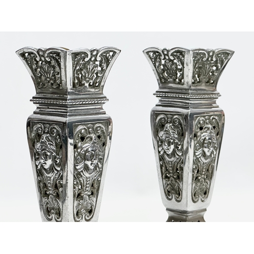 2 - James Cartland & Co. A pair of Late 19th Century polished pierced vases. Makers mark. 23cm.