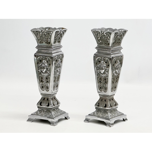 2 - James Cartland & Co. A pair of Late 19th Century polished pierced vases. Makers mark. 23cm.