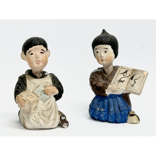 218 - A pair of Early 20th Century Japanese pottery nodder dolls. 8cm.