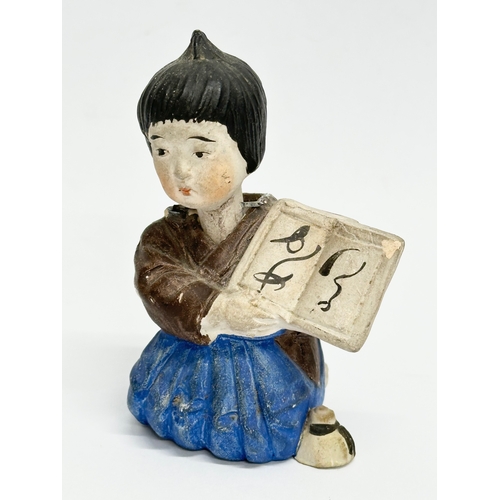 218 - A pair of Early 20th Century Japanese pottery nodder dolls. 8cm.