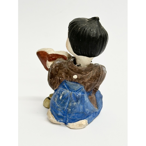 218 - A pair of Early 20th Century Japanese pottery nodder dolls. 8cm.