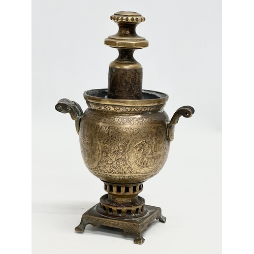 378 - A pair of small 19th Century Islamic style engraved brass samovars. 23cm