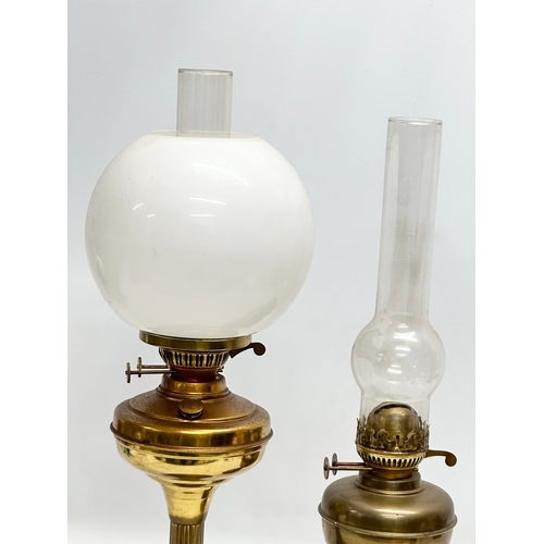 676 - 2 Mid 20th Century brass double burner oil lamps. 58cm