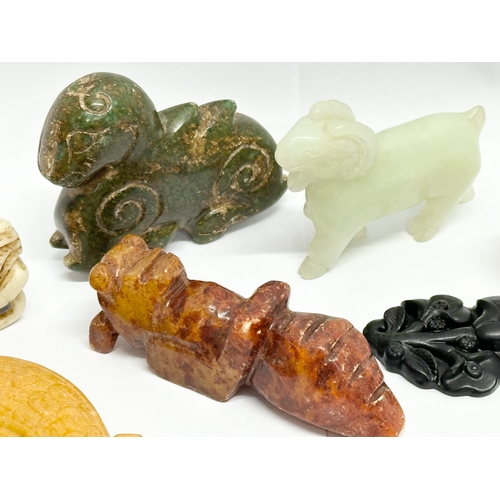 329 - A collection of Chinese carved jade, opal stone and soapstone figures.