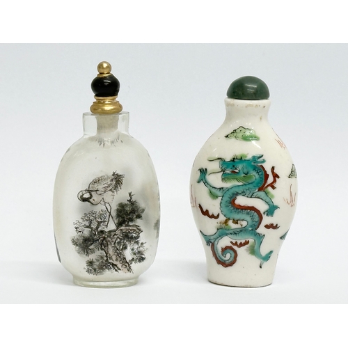 330 - Two Chinese snuff bottles/scent bottles. A hand painted glass Zhou Leyuan style snuff bottle. An Ear... 