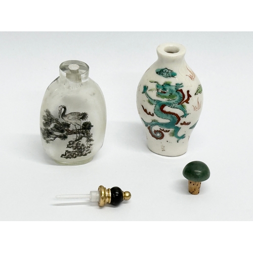 330 - Two Chinese snuff bottles/scent bottles. A hand painted glass Zhou Leyuan style snuff bottle. An Ear... 