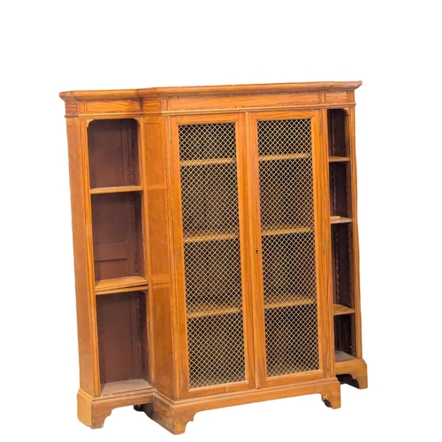 824 - A 18th Century style inlaid Satinwood breakfront bookcase with brass wired mesh door in the Sheraton... 