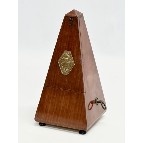 648 - Maelzel Paquet. A 20th Century mahogany cased metronome. 23cm.