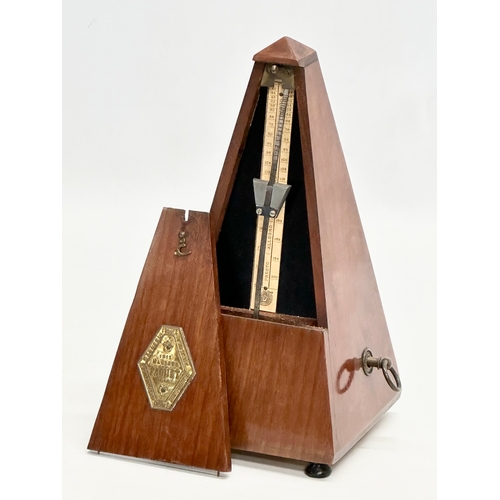 648 - Maelzel Paquet. A 20th Century mahogany cased metronome. 23cm.