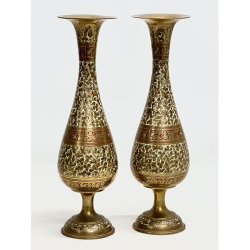 806 - A pair of tall Mid 20th Century Indian engraved brass vases. 36cm