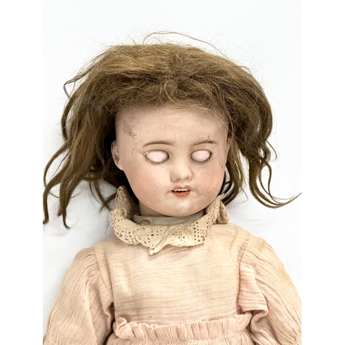 706 - A large Early 20th Century French porcelain doll. By S.F.B.J, Paris. 52cm