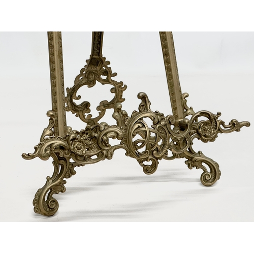 714 - A pair of large rococo style brass table top easels. 27x26x54cm