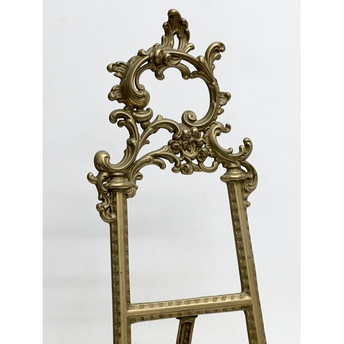 714 - A pair of large rococo style brass table top easels. 27x26x54cm