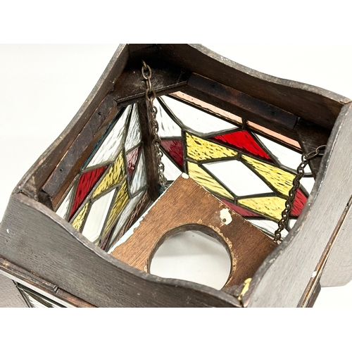 189 - A 1920’s Art Deco oak framed lantern light fitting, with 4 stained glass panels. 27x27x37cm