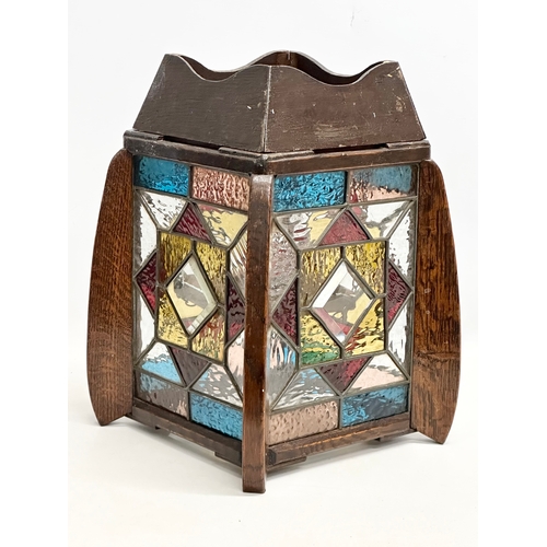 189 - A 1920’s Art Deco oak framed lantern light fitting, with 4 stained glass panels. 27x27x37cm