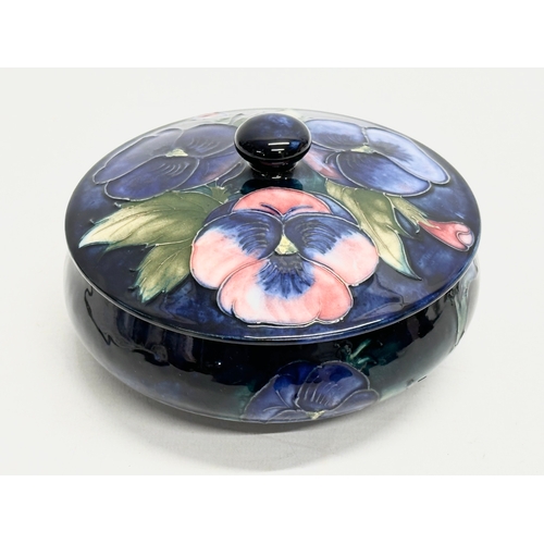 342 - A signed Early 20th Century William Moorcroft “Pansy” powder dish/trinket dish with cover 14x10cm.