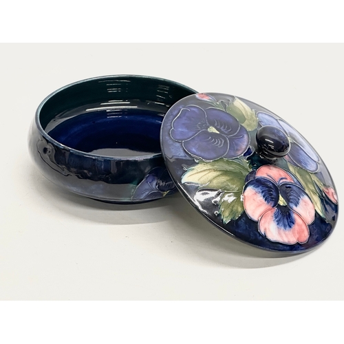 342 - A signed Early 20th Century William Moorcroft “Pansy” powder dish/trinket dish with cover 14x10cm.