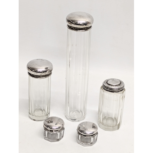 720 - A quantity of Early to Mid 20th Century glass vanity bottles with silver lids. 17.5cm