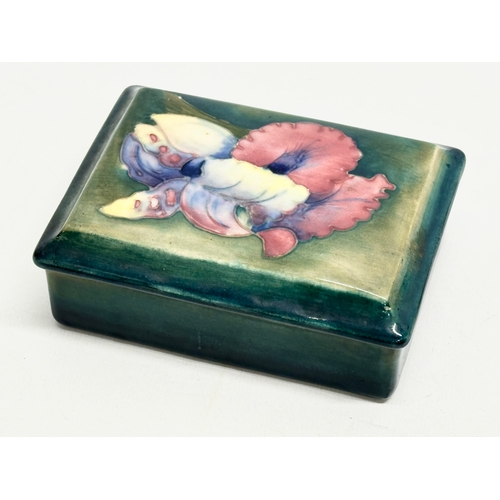 336 - A signed William Moorcroft “Orchard” trinket box with cover. 12x9x4.5cm.