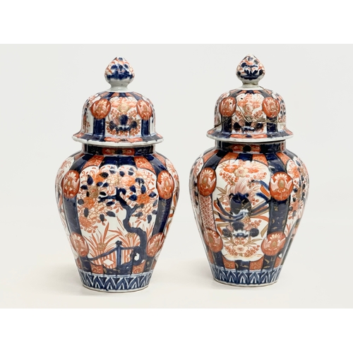 816 - A pair of Late 19th Century Japanese Imari jars with covers. Meiji Period (1868-1912) 15x33cm.