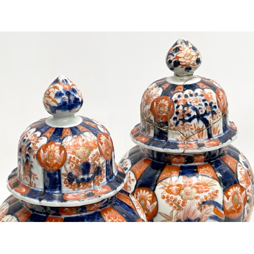 816 - A pair of Late 19th Century Japanese Imari jars with covers. Meiji Period (1868-1912) 15x33cm.