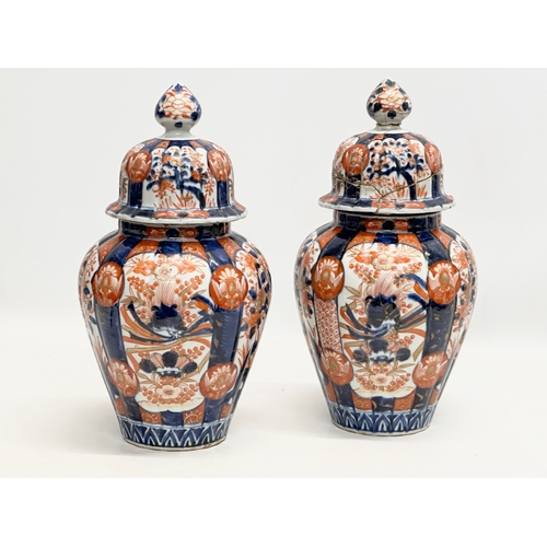 816 - A pair of Late 19th Century Japanese Imari jars with covers. Meiji Period (1868-1912) 15x33cm.