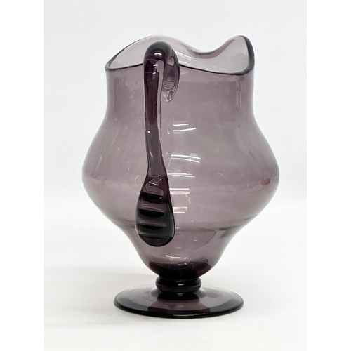 251 - An Early 20th Century George III style amethyst glass water jug. 19x15x20cm.