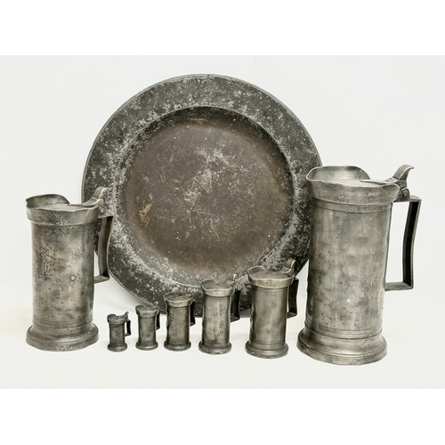 415 - A collection of 19th Century French pewter. 7 pewter measures/tankards and a pewter tray. Largest me... 