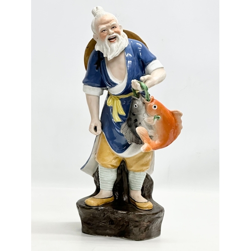 350 - A large Chinese fisherman statue. Impressed marks. 42cm