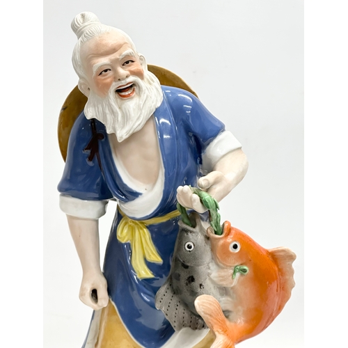 350 - A large Chinese fisherman statue. Impressed marks. 42cm