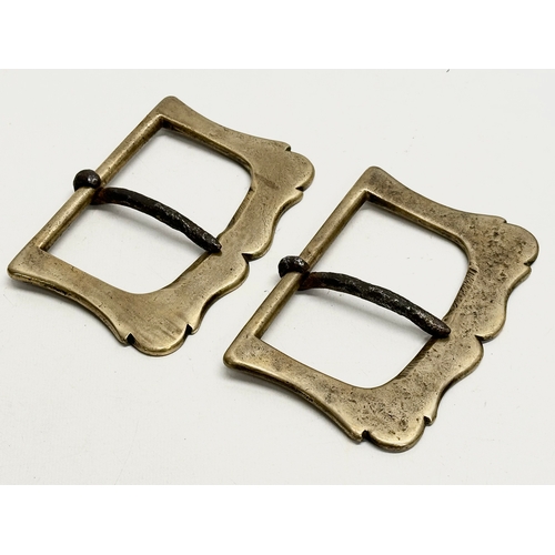 351 - A pair of large 18th/19th Century brass belt buckles. 13x9cm.