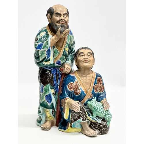 340 - A large Japanese statue of immortals. 20x32cm.