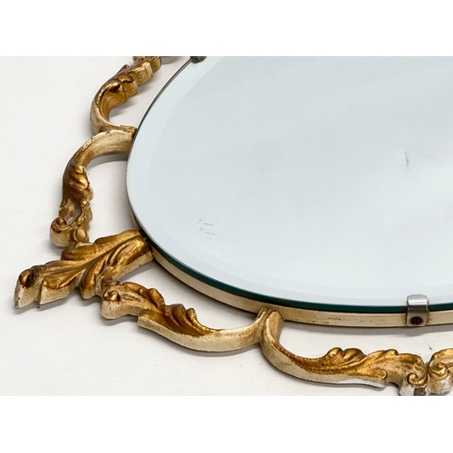 928 - A Mid 20th Century brass framed mirror with bevelled glass. 68x48cm