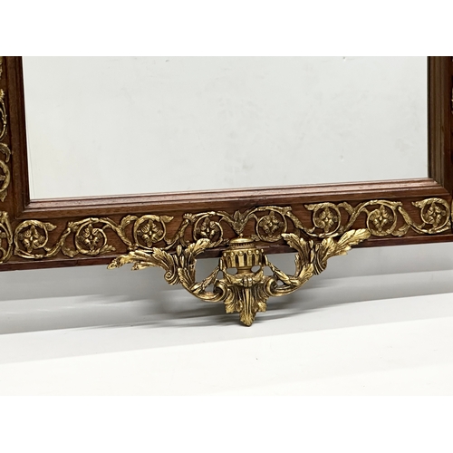 331 - A large Neo Classical style gilt brass and mahogany framed mirror. 58x101cm