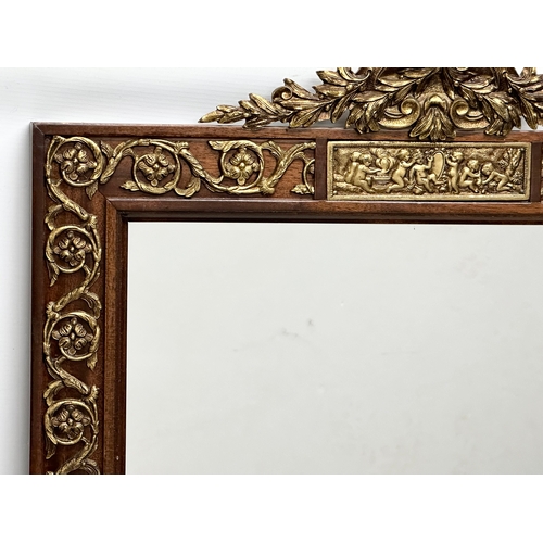 331 - A large Neo Classical style gilt brass and mahogany framed mirror. 58x101cm