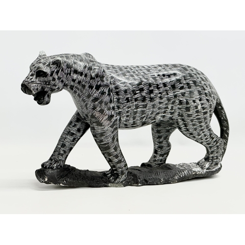 446 - A large polished stone leopard. 49x30cm.