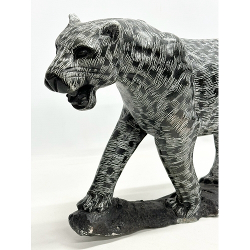 446 - A large polished stone leopard. 49x30cm.