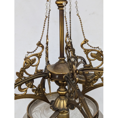 229 - A good quality Early 20th Century brass chandelier with glass shade. 63x77cm