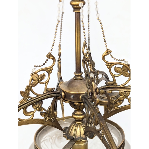 229 - A good quality Early 20th Century brass chandelier with glass shade. 63x77cm