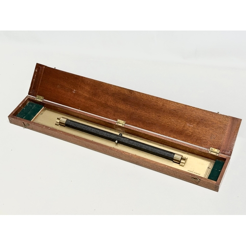 744 - A vintage brass parallel rolling ruler, with case. 63cm