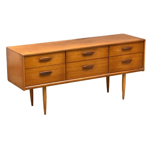 169 - Frank Guille for Austinsuite. A 1960’s Mid Century teak sideboard. Designed by Frank Guille for Aust... 