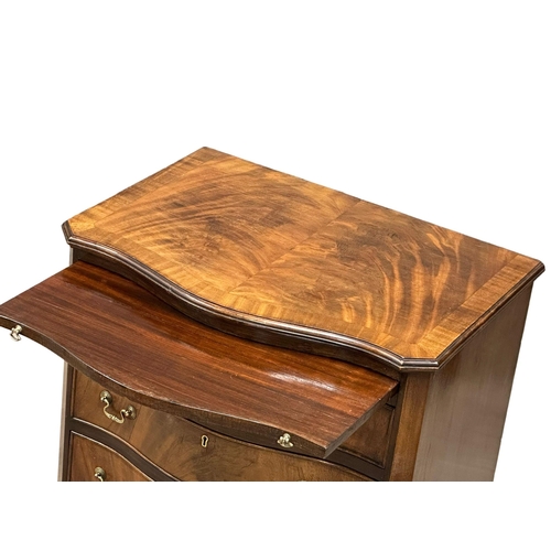 174 - An Early 20th Century Chippendale Revival mahogany serpentine front bachelors chest, on bracket feet... 