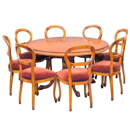 550A - A large inlaid pedestal dining table with 8 balloon back chairs. 142cm. 3