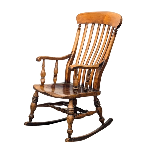 222 - A 19th Century Victorian elm and beech rocking chair. 2