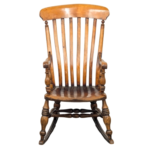 222 - A 19th Century Victorian elm and beech rocking chair. 2