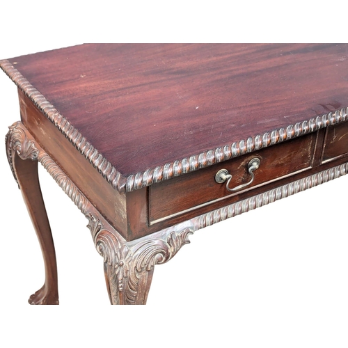 223 - An Irish Chippendale style mahogany sofa table with 3 drawers and 3 dummy drawers on Ball & Claw fee... 